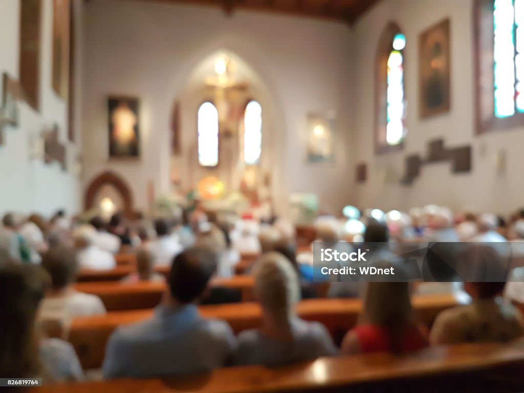 Blurred photo of praying people in the church for abstract background